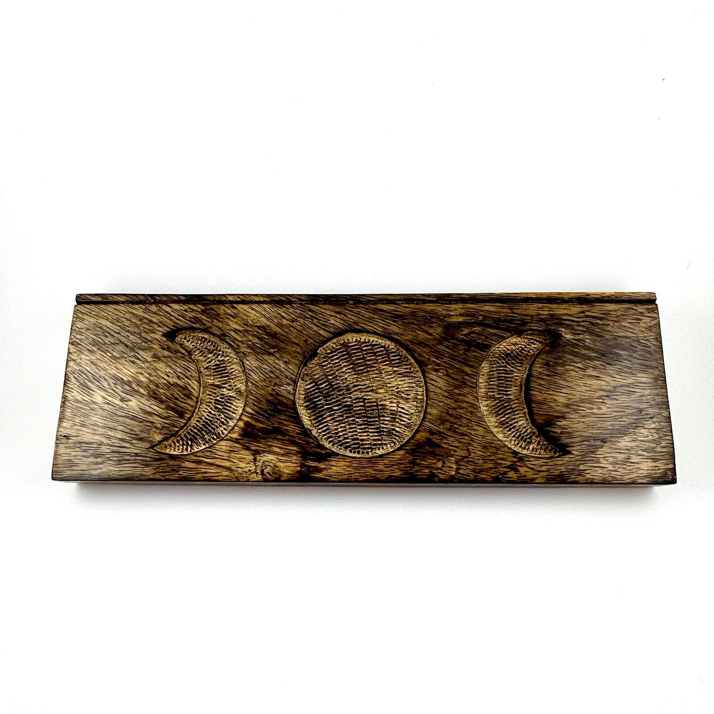 Wooden plaque with engraved moon phases on a white background