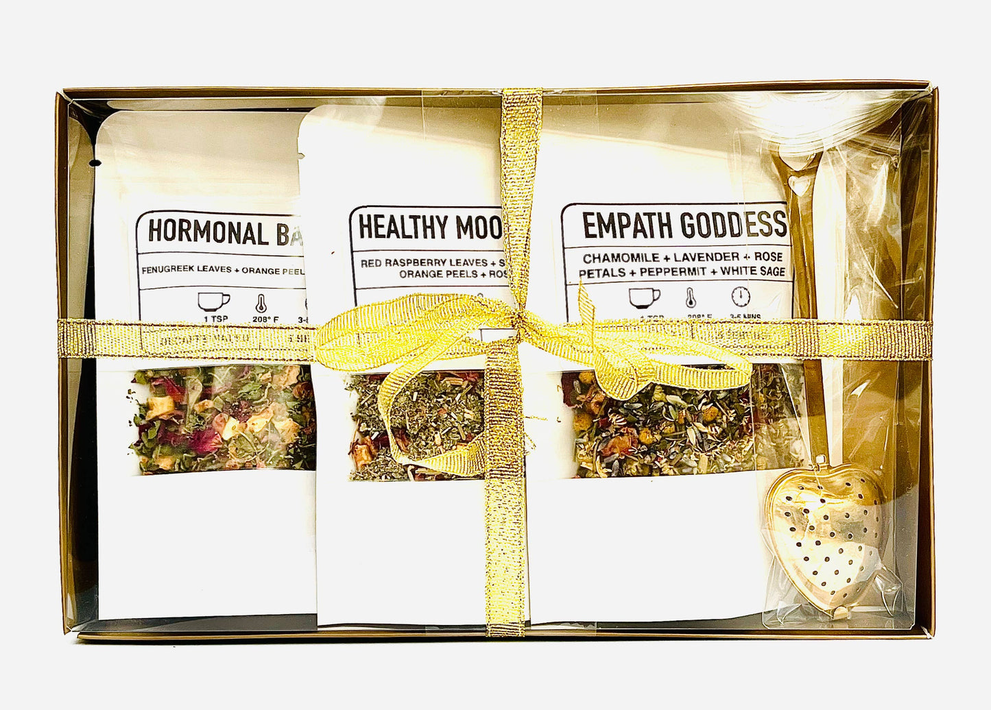 Packaged herbal tea set with visible brand names in a gold box.