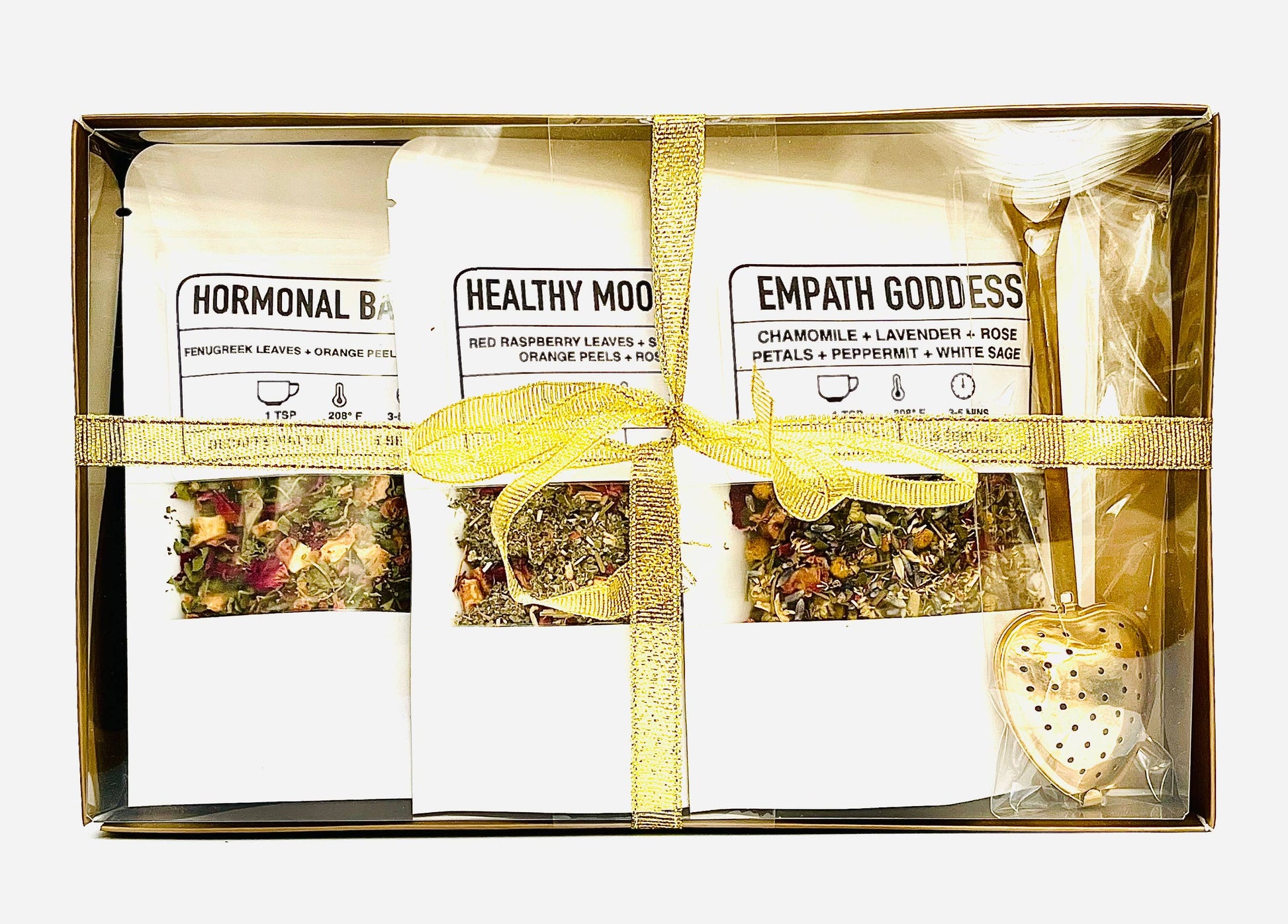 Packaged herbal tea set with visible brand names in a gold box.