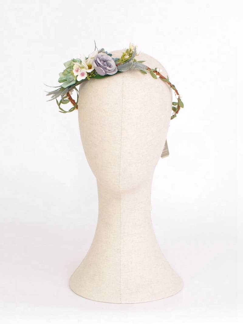 Floral headband on a mannequin head against a white background