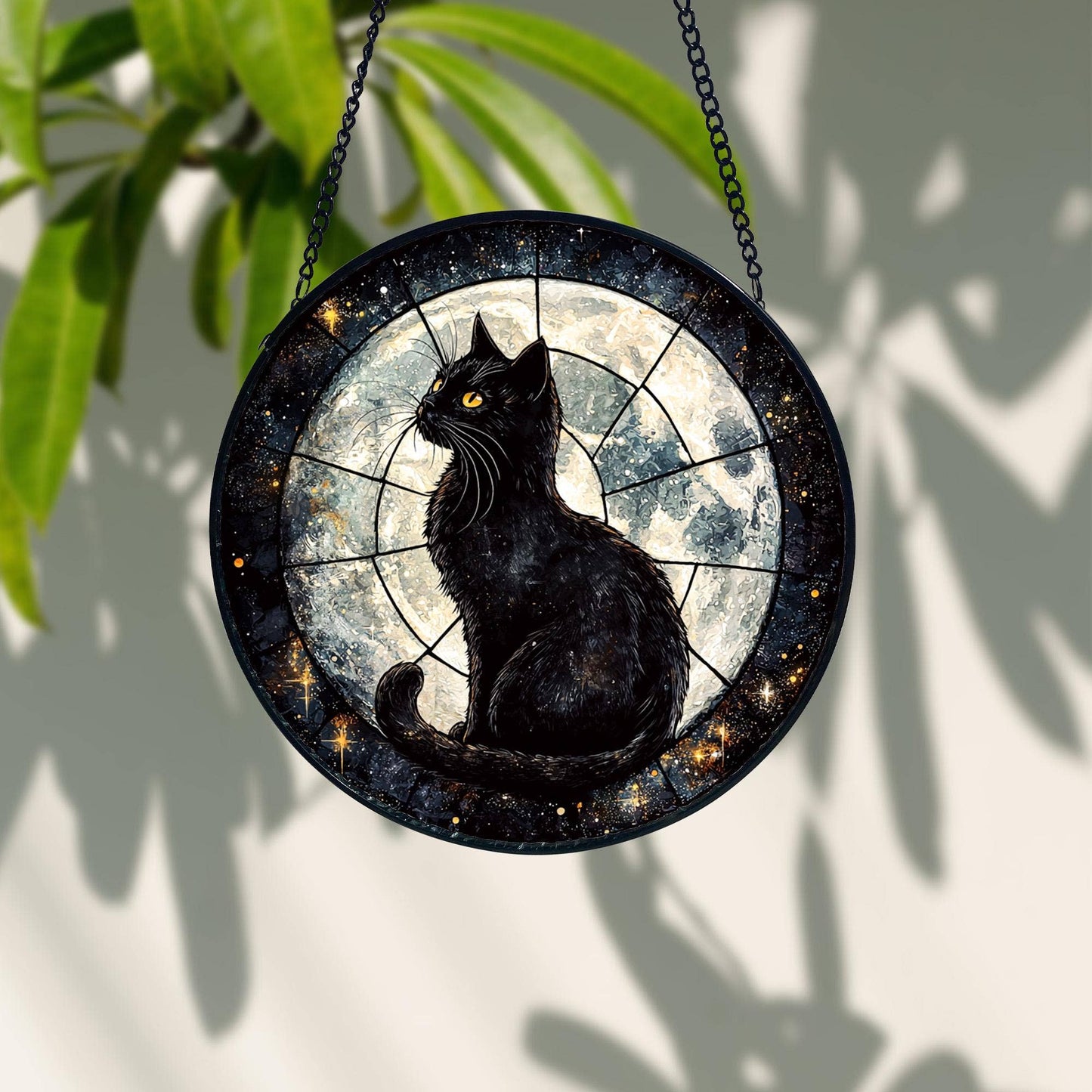 Decorative wall hanging with a black cat design against a starry night sky.