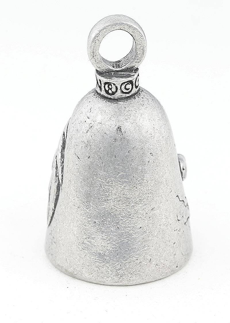Silver bell with engraved design on a white background