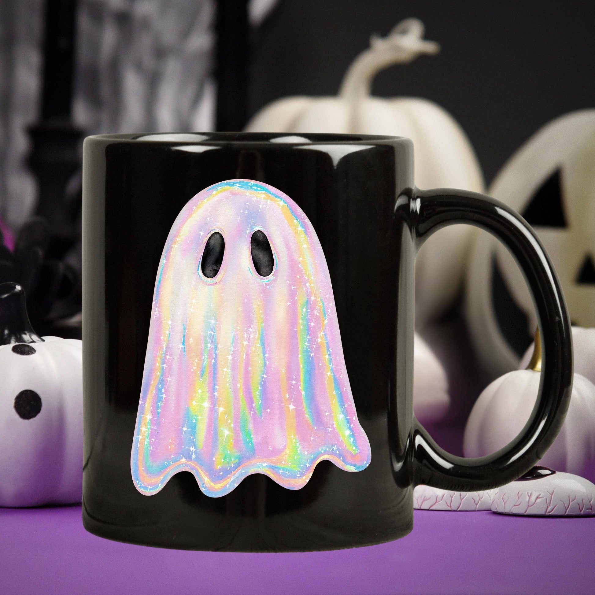 Black mug with a colorful ghost design against a Halloween-themed background