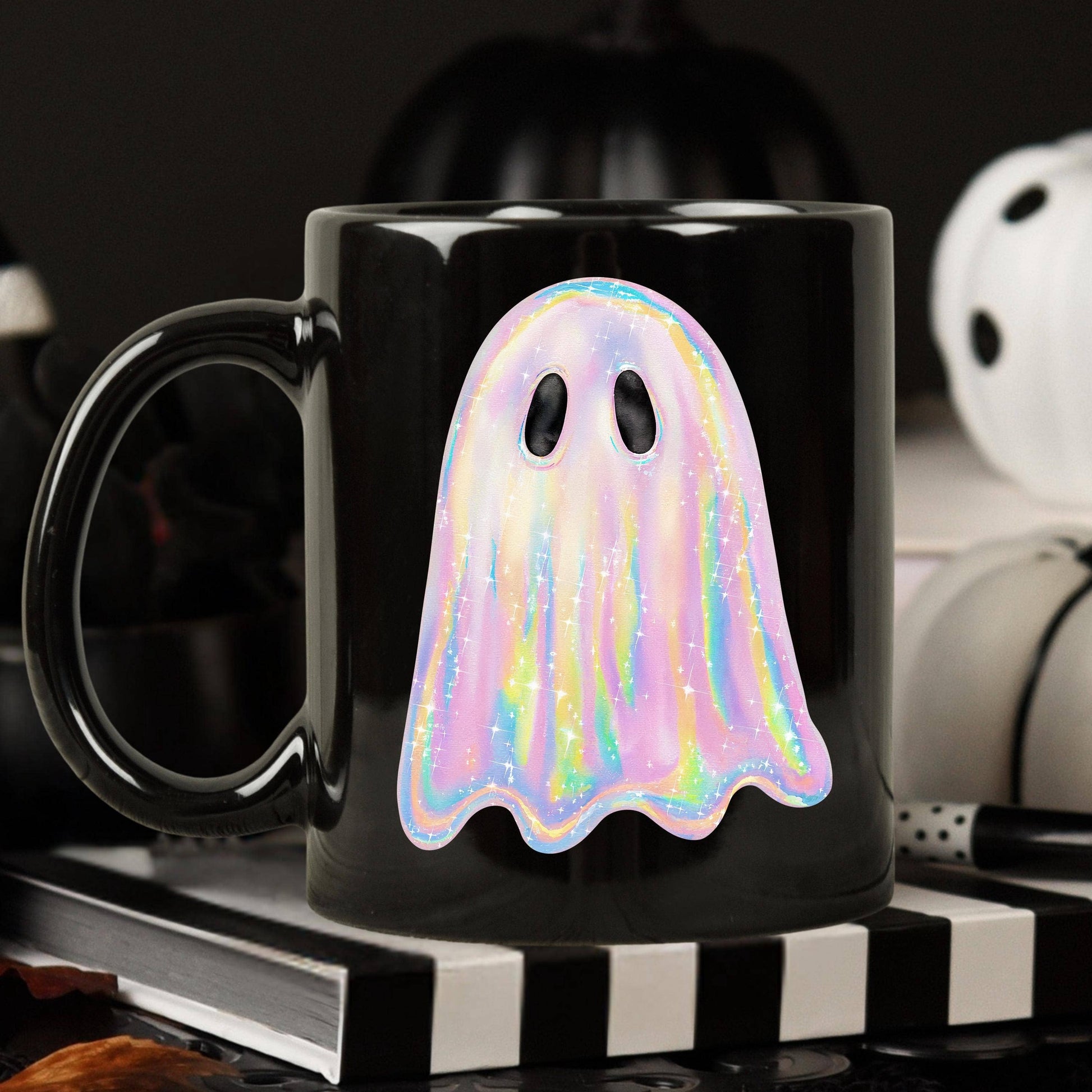 Black mug with a colorful ghost design on a dark background