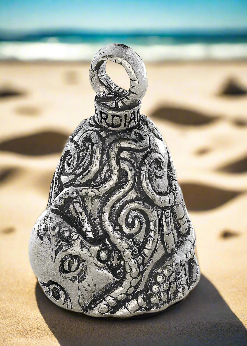 Silver bell-shaped pendant with intricate designs on a white background