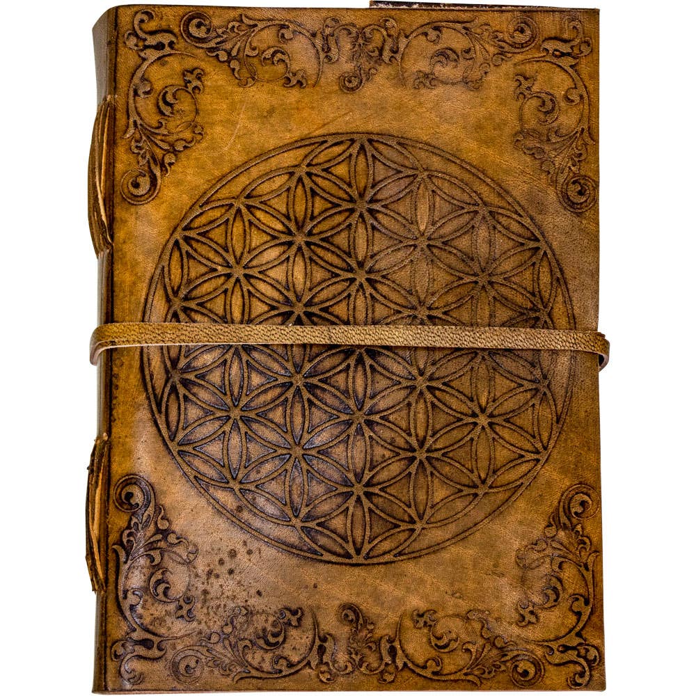 Brown leather journal with intricate designs and a central geometric pattern on a white background
