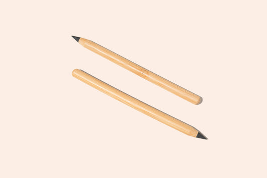 Two bamboo pencils with alloy tips, one with the tip facing up and the other with the tip facing down, against a white background.