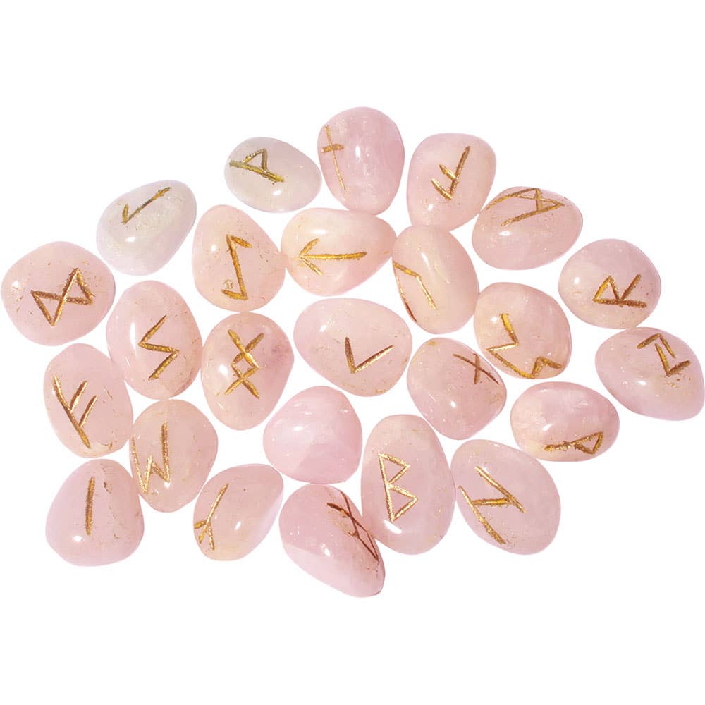 Rose quartz stones with gold runes on a white background