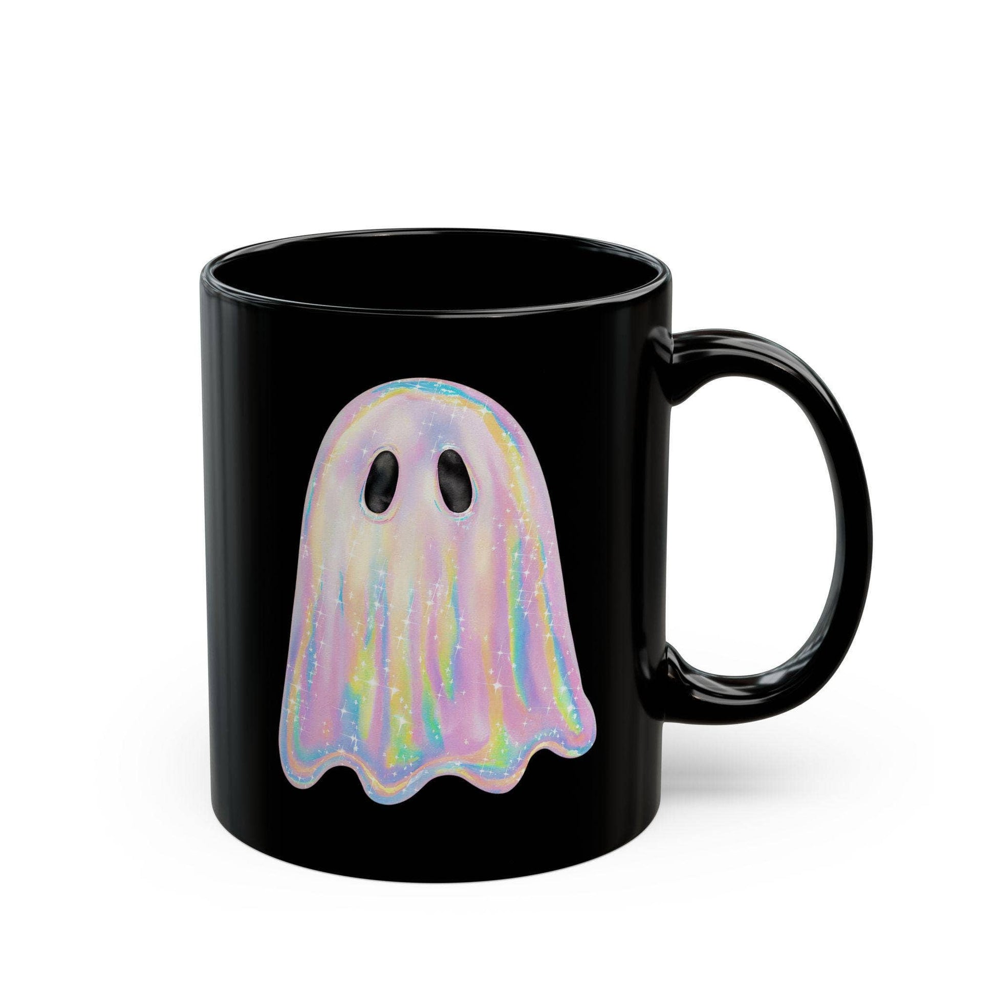 Black mug with a colorful ghost design on a white background