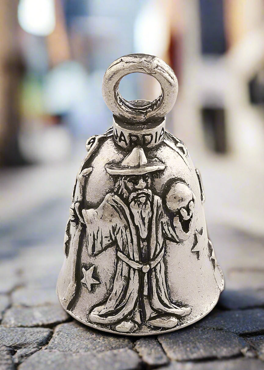 Silver bell with a wizard design on a white background