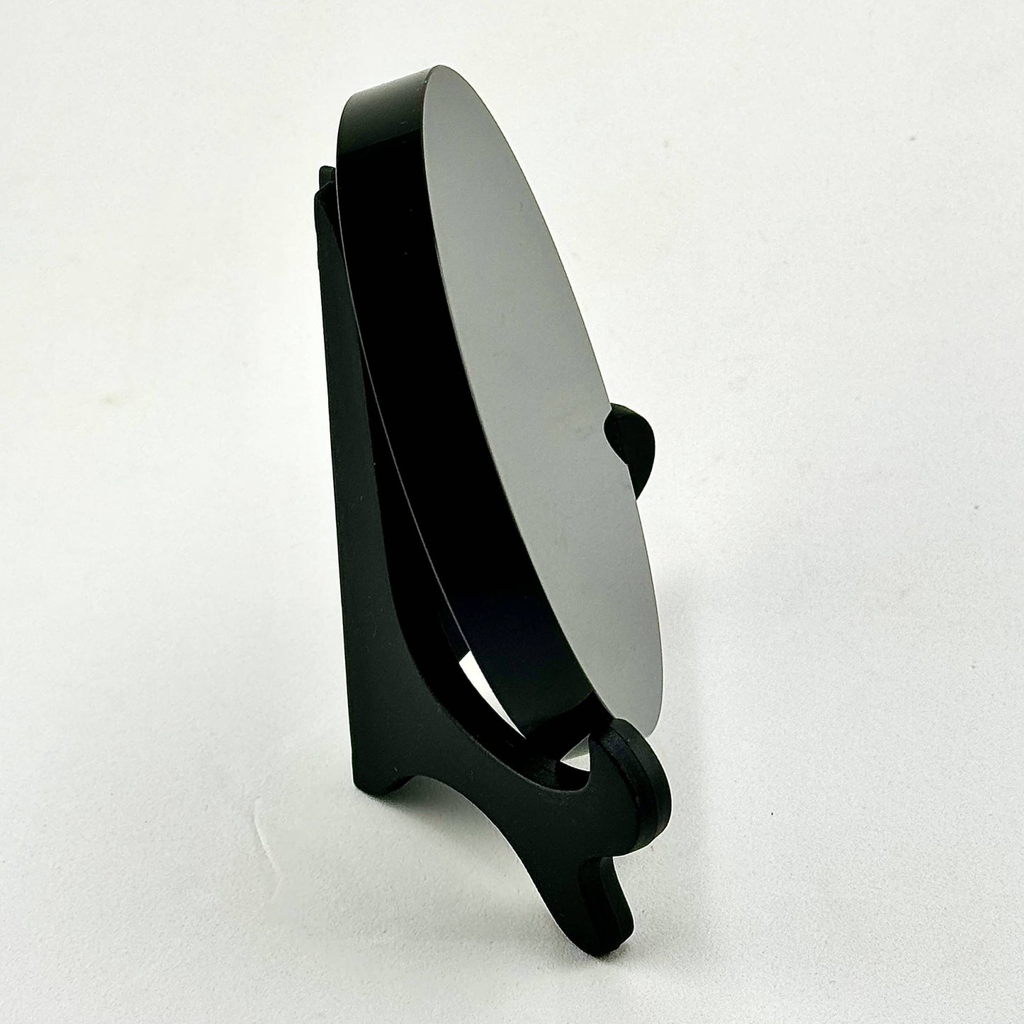 Black stand with a scrying mirror on a white background
