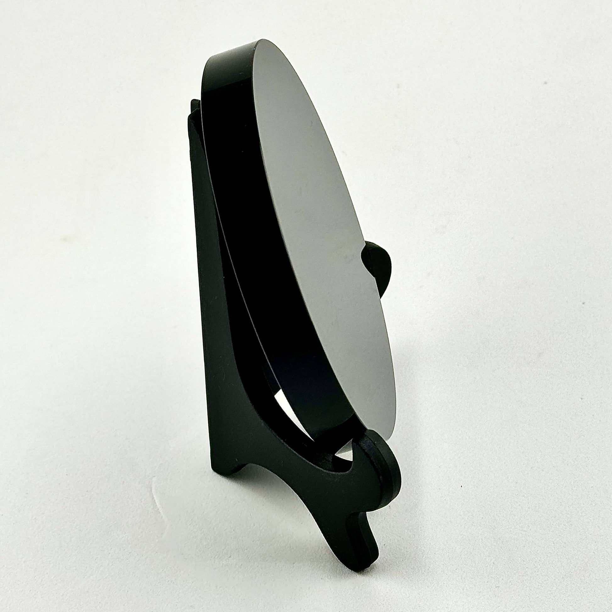 Black stand with a scrying mirror on a white background